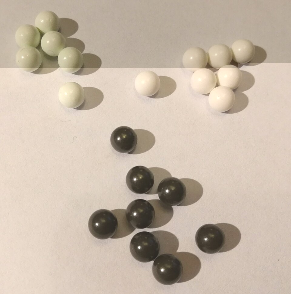 Assorted airsoft BBs of different weights next to their packaging
